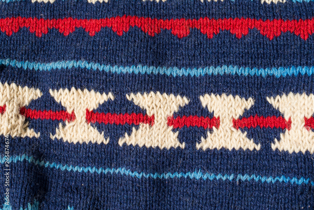 Obraz premium Knitted texture with blue pattern close up