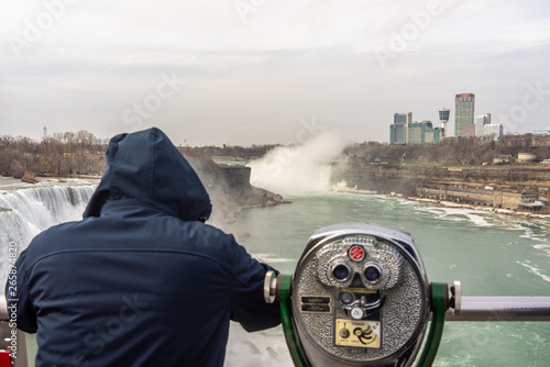 USA, Niagara Falls, April 2019: A coin operated binocular viewer located in Niagara Falls with a view to the falls