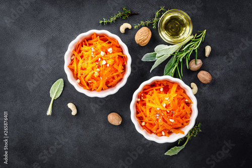 Fresh carrot salad with oil and nuts