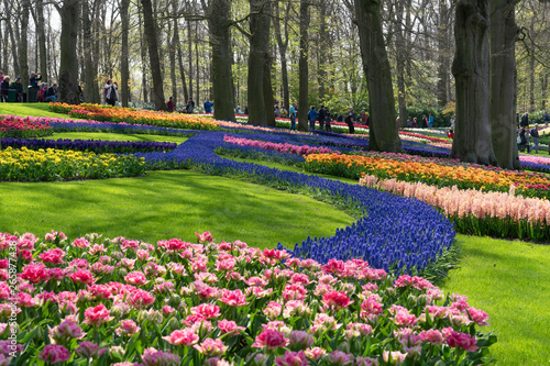 Tourists walk and take photos in the flower Park Keukenhof Holland