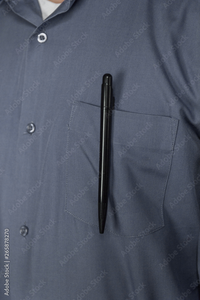 man in grey shirt with pen in pocket man in grey shirt with pen in pocket