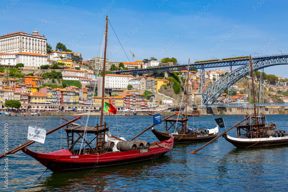 Traditional Rabelo boat designed to carry wine down Douro river with city skyline behind, Porto, Portugal Traditional Rabelo boat designed to carry wine down Douro river with city skyline behind, Porto, Portugal
