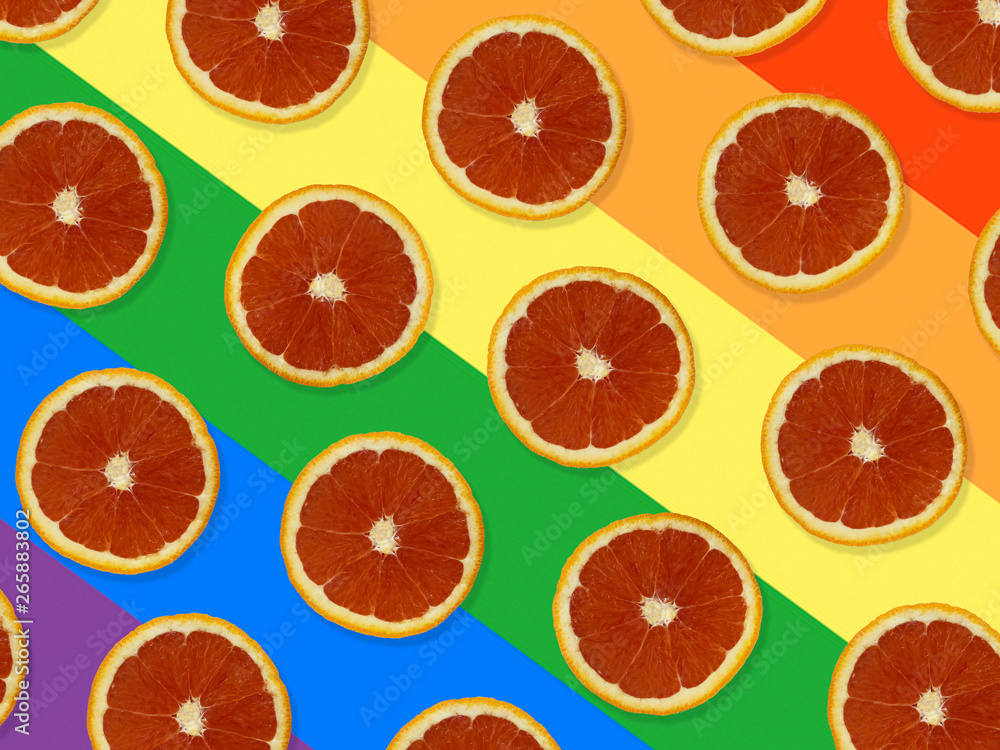 Creative pattern made of red oranges. top view of colorful fruit pattern of fresh red orange slices on colorful background. The rainbow flag, LGBT background Creative pattern made of red oranges. top view of colorful fruit pattern of fresh red orange slices on colorful background. The rainbow flag, LGBT background