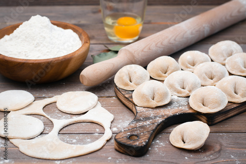 The process of molding dumplings and ingredients for cooking on a wooden table