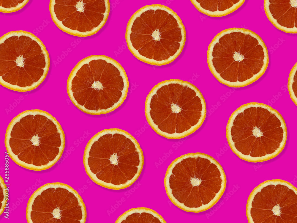 Creative pattern made of red oranges. top view of colorful fruit pattern of fresh red orange slices on pink colorful background. Creative pattern made of red oranges. top view of colorful fruit pattern of fresh red orange slices on pink colorful background.