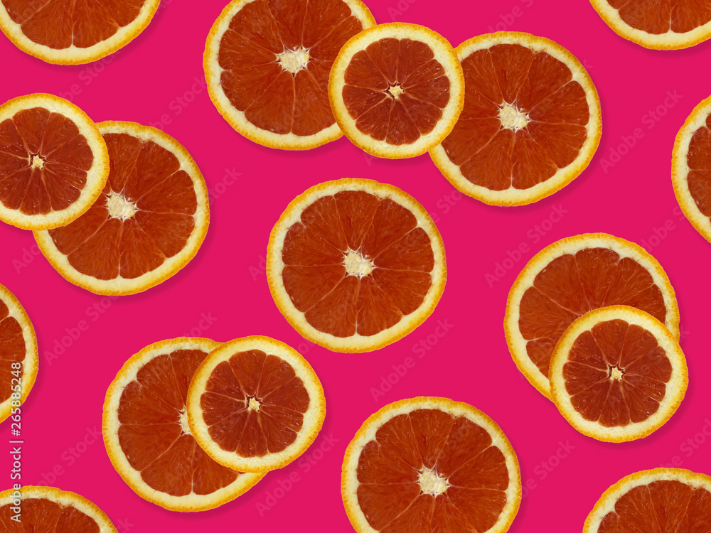 Creative pattern made of red oranges. top view of colorful fruit pattern of fresh red orange slices on pink colorful background. Creative pattern made of red oranges. top view of colorful fruit pattern of fresh red orange slices on pink colorful background.
