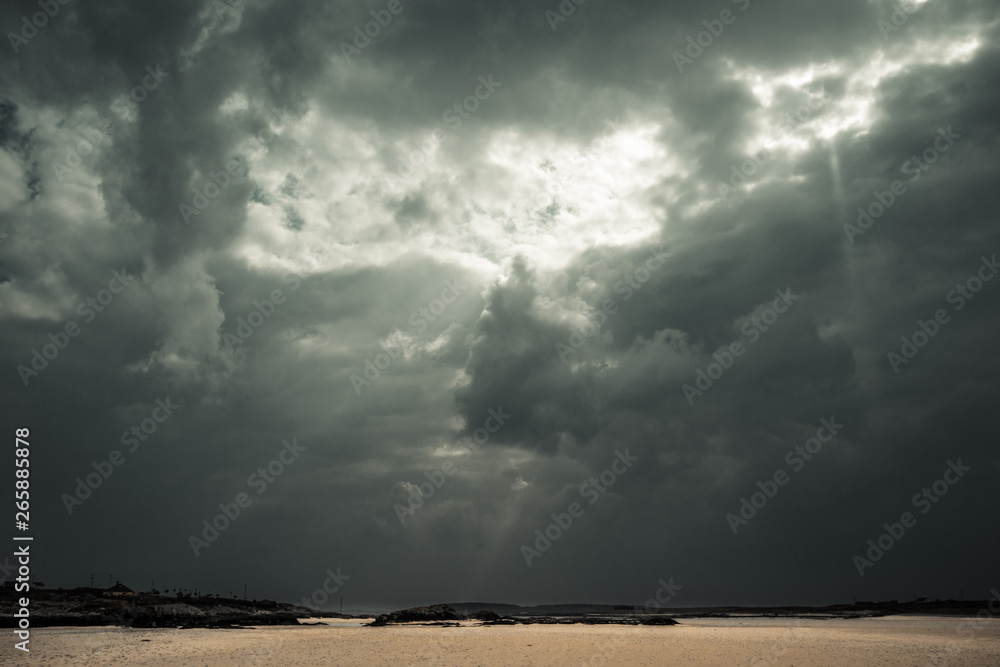 une plage déserte sous un ciel orageux