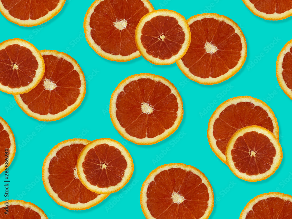 Creative pattern made of red oranges. top view of colorful fruit pattern of fresh red orange slices on blue colorful background. Creative pattern made of red oranges. top view of colorful fruit pattern of fresh red orange slices on blue colorful background.