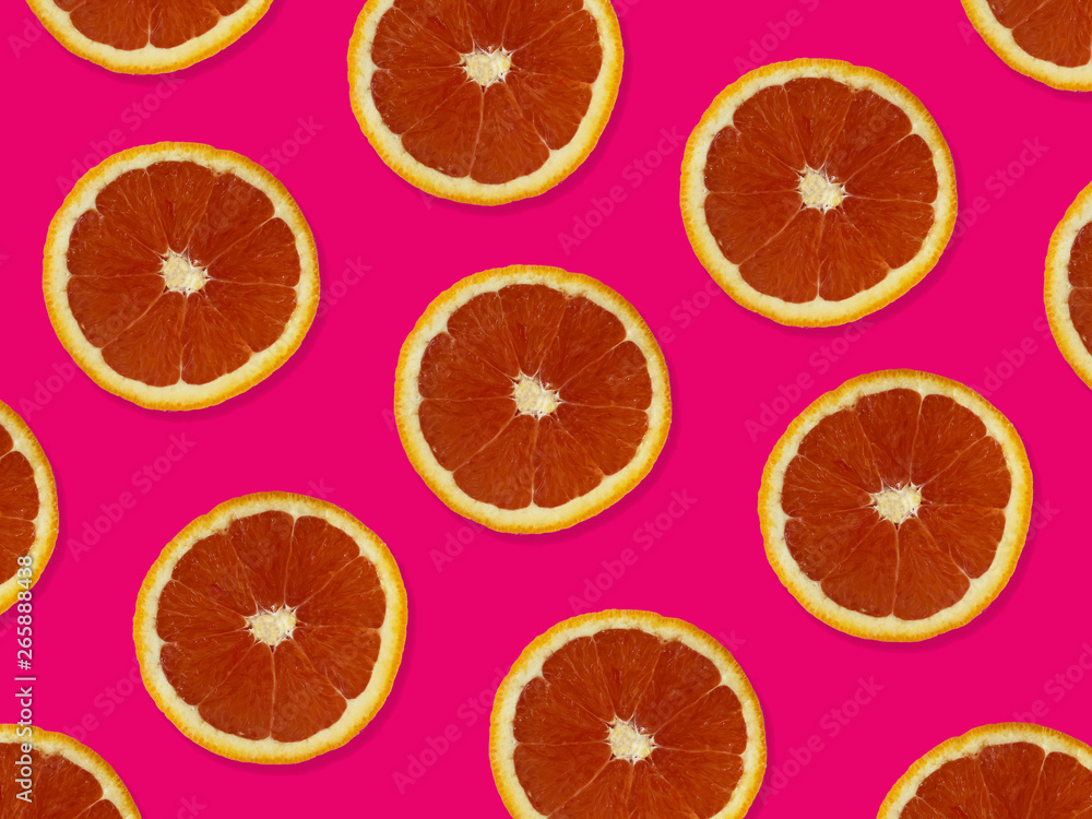 Creative pattern made of red oranges. top view of colorful fruit pattern of fresh red orange slices on pink colorful background. Creative pattern made of red oranges. top view of colorful fruit pattern of fresh red orange slices on pink colorful background.