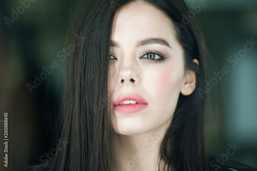 Close up portrait of beautiful young brunette woman  © alipko