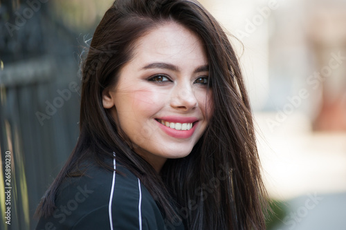 Beautiful smiling young woman wearing black jacket