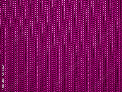Close-up of purple fabric plastic textile lattice or grid texture. Horizontal and vertical crossover lines. A lattice work of interwoven purple plastic textile textured strips forms pattern background