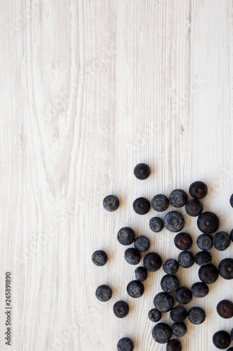 Blueberries on a white wooden background, top view. Flat lay, overhead, from above. Copy space.