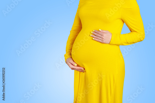 Woman waiting for a baby carefully hollding her bellly photo