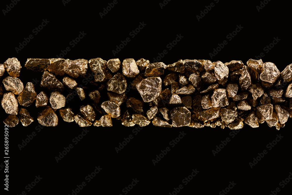 top view of golden textured stones in horizontal row isolated on black top view of golden textured stones in horizontal row isolated on black