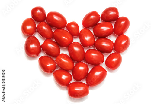 Heart of small cherry tomatoes. Concept of love and symbol of healthy nutrition. Isolate on a white background