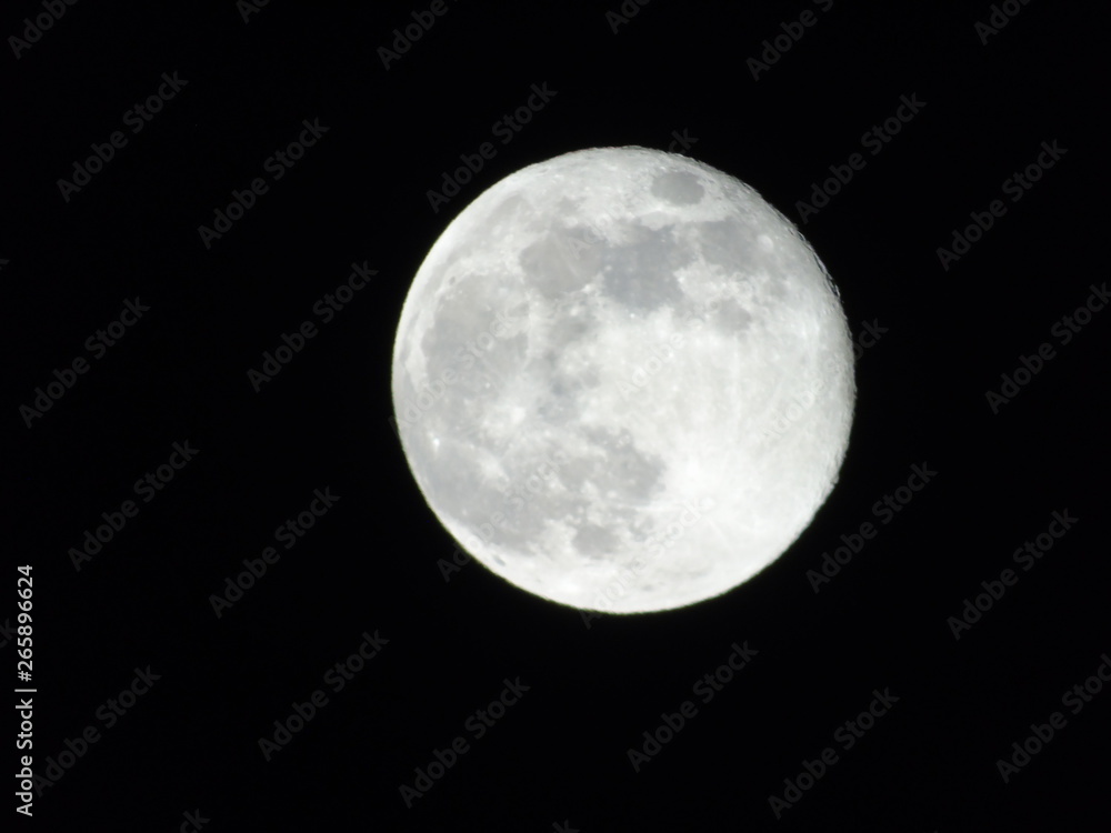 Genova, Italy - 03/22/2019: An amazing photography of the full moon over the city of Genova by night with a great clear sky in background and some stars Genova, Italy - 03/22/2019: An amazing photography of the full moon over the city of Genova by night with a great clear sky in background and some stars