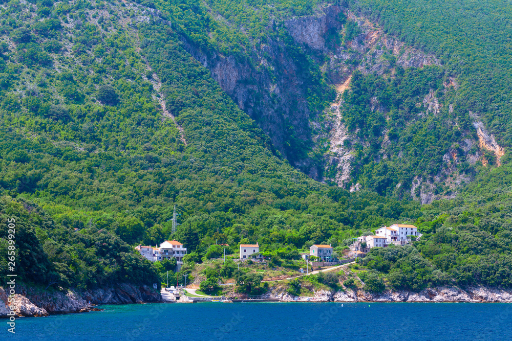 The small village Merag on island Cres in the Adriatic Sea in Croatia. Wonderful romantic summertime seascape with crystal clear azure sea and emerald green coastline slopes.