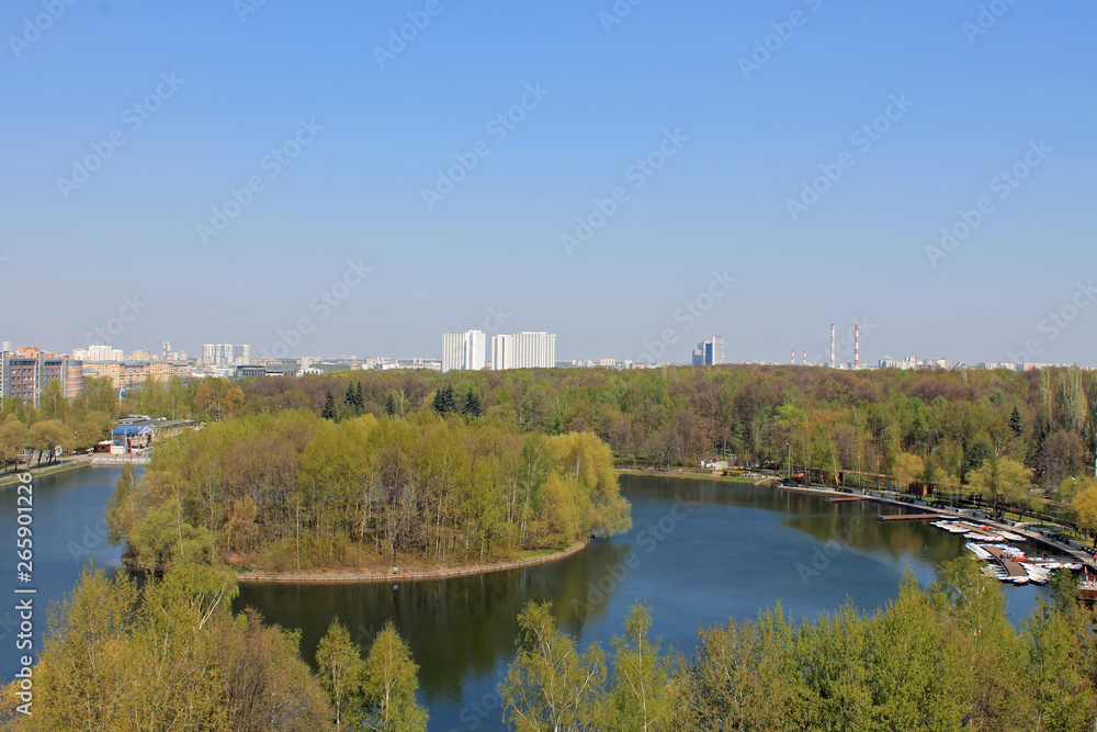 Panoramic view of the round pond and round island in the center of the pond in Izmailovsky Park in Moscow Russia on a spring day Panoramic view of the round pond and round island in the center of the pond in Izmailovsky Park in Moscow Russia on a spring day