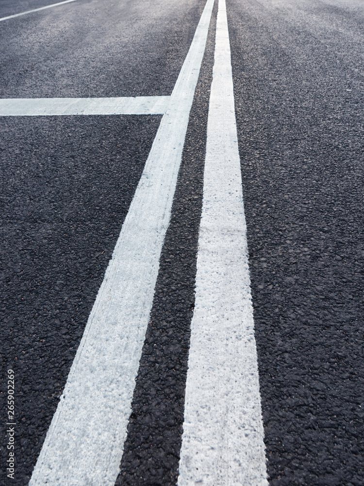 Road with white marking diminishing perspective Road with white marking diminishing perspective