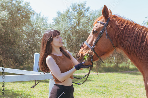 female rider cares for her horse