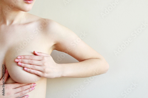 Woman controlling breast for cancer, isolated on white background.