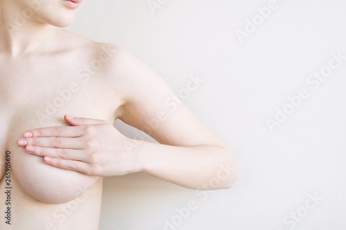 Woman controlling breast for cancer, isolated on white background.
