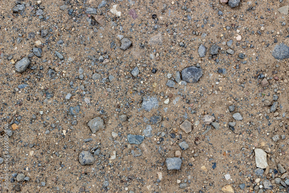 Sandy texture, coast, river bank. Large sand with small stones, bright sunlight. Rest, summer, beach. Sandy texture, coast, river bank. Large sand with small stones, bright sunlight. Rest, summer, beach.