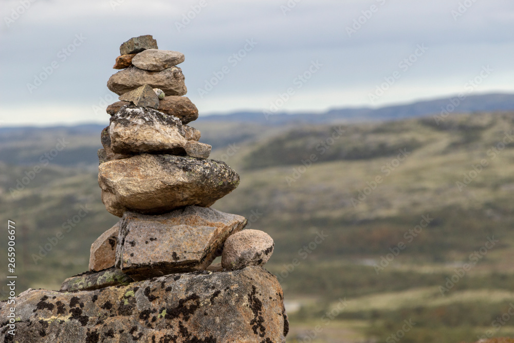 Stones stacked for Norwegian fairytale trolls. Relief and texture of stone with patterns and moss. Stone natural background. Stone with Moss. Stones boulders covered with moss. Stones stacked for Norwegian fairytale trolls. Relief and texture of stone with patterns and moss. Stone natural background. Stone with Moss. Stones boulders covered with moss.