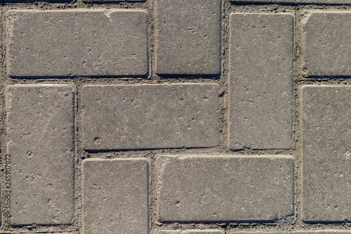 Grey paving stones as background. Grey granite cobblestone. Close-up. Top view.