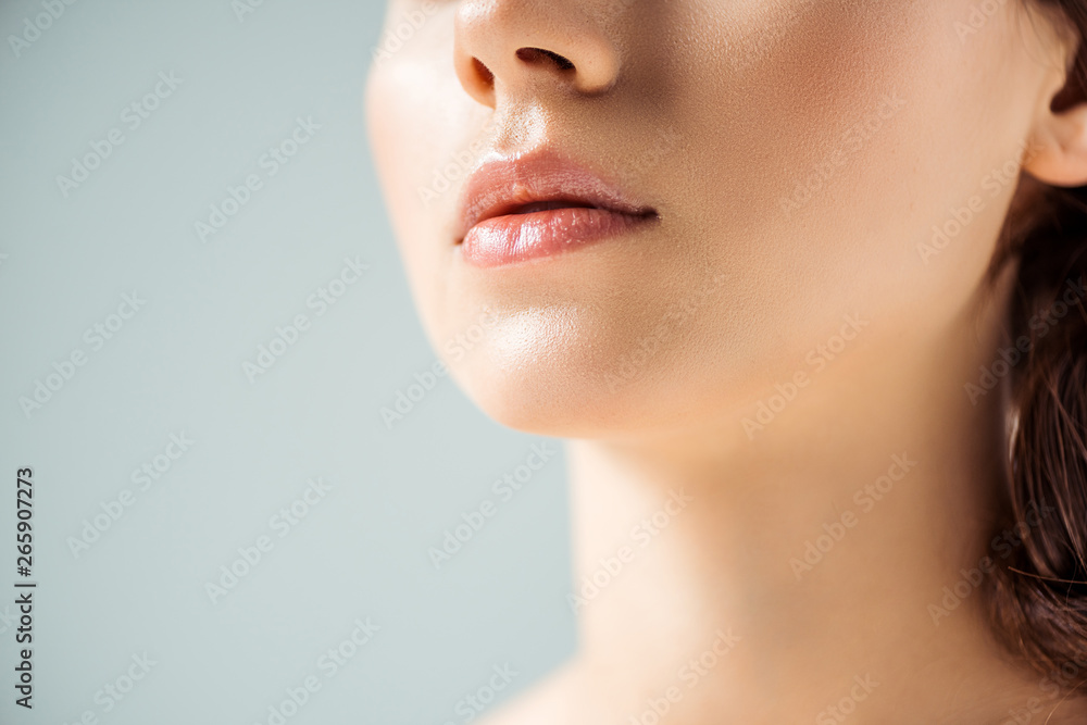 cropped view of young woman with shiny lips on grey background cropped view of young woman with shiny lips on grey background