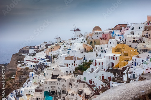 View of colorful and pictoresque village of Oia on a rare rainy day