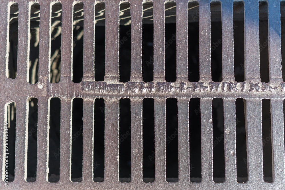 Front view of steel drainage grating of the asphalt road. Steel grate ...