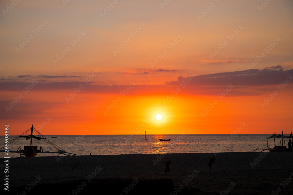 Sunset sky and sea landscape with wooden boat. Romantic seascape on tropical island. Summer vacation travel card