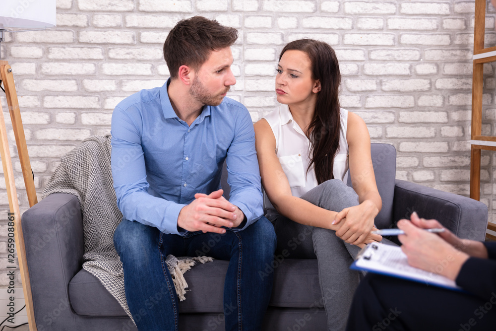 Female Consultant Sitting With Couple Female Consultant Sitting With Couple