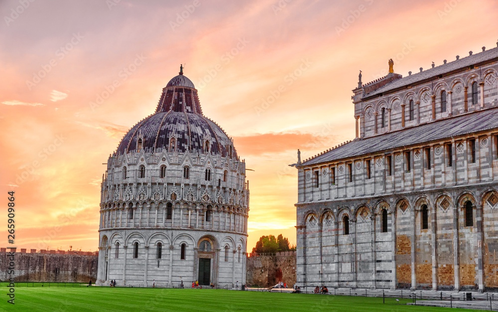Obraz premium Pisa, Italy. Beautiful sunset view of Pisa Baptistery of St. John, Battistero di San Giovanni. Roman Catholic ecclesiastical building in Pisa. UNESCO world heritage site. Iconic travel landmark.