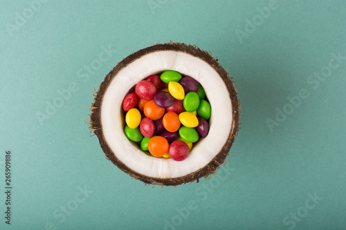 Coconut with colorful candies.