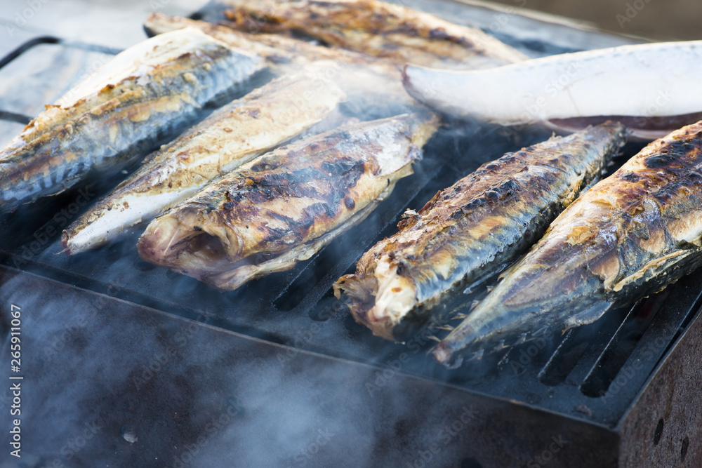 Barbecue with fish, mackerel fish on fire grill