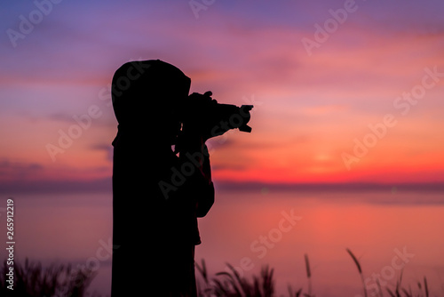 silhouette of girl with camera