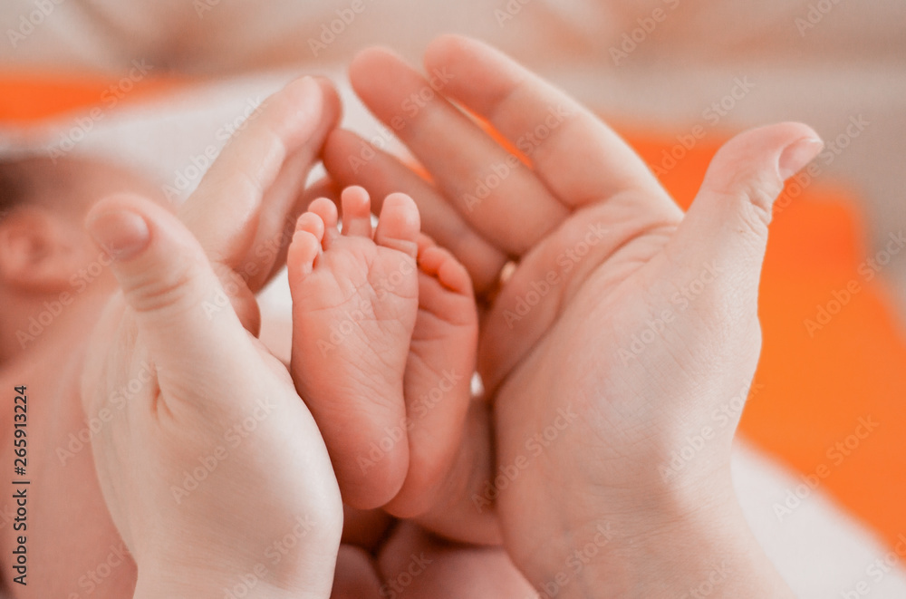 Pregnancy, maternity, preparation and expectation motherhood, giving birth concept. Newborn baby feet in hands of mommy Pregnancy, maternity, preparation and expectation motherhood, giving birth concept. Newborn baby feet in hands of mommy