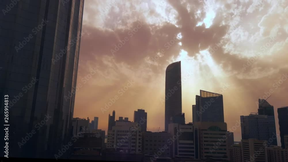 Time lapse of Abu Dhabi city skyscrapers and skyline at sunset on a cloudy day Time lapse of Abu Dhabi city skyscrapers and skyline at sunset on a cloudy day