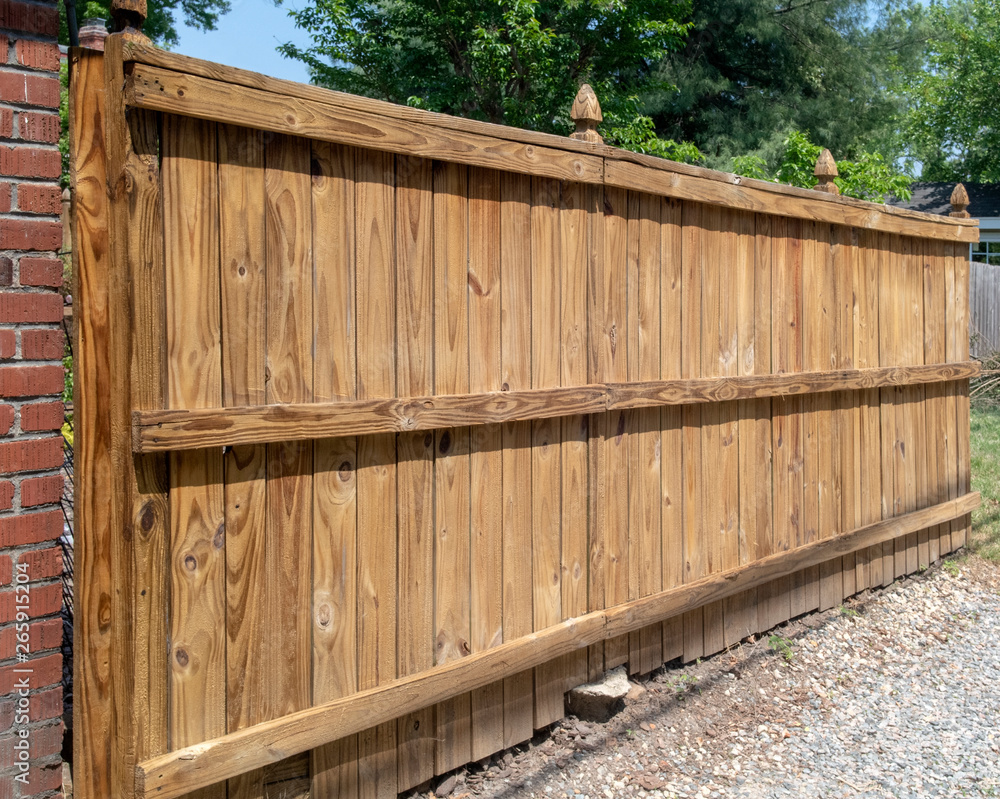 New brown fence erected behind home in alley. New brown fence erected behind home in alley.