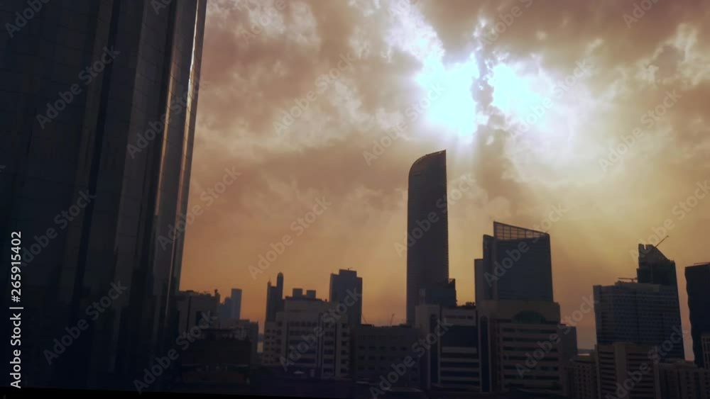 Time lapse of Abu Dhabi city skyscrapers and skyline at sunset on a cloudy day Time lapse of Abu Dhabi city skyscrapers and skyline at sunset on a cloudy day