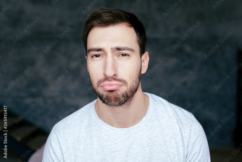 front view of handsome sad man with beard front view of handsome sad man with beard