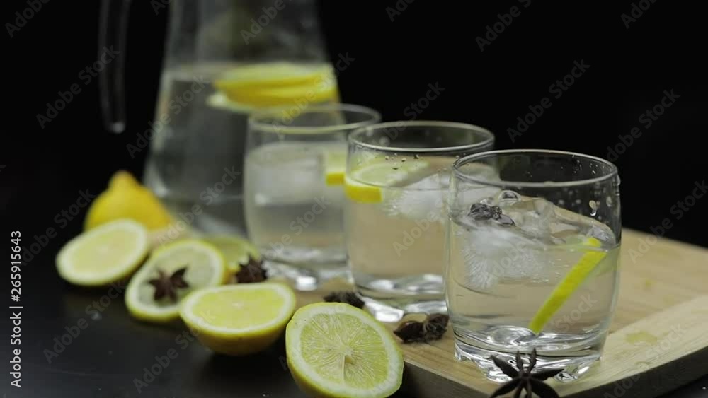 Add ice cubes to lemon juice in glass with lemon slices. Alcoholic cocktail Add ice cubes to lemon juice in glass with lemon slices. Alcoholic cocktail