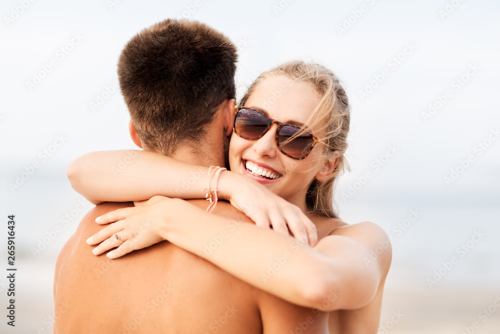 love, summer holidays and people concept - happy couple hugging on beach love, summer holidays and people concept - happy couple hugging on beach