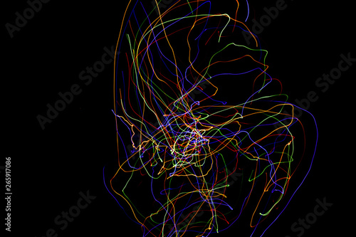 Abstract colorful lines on black background. Light painting photography with irregular patterns for overlay. Resource for designers.