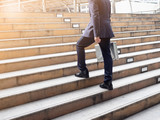 Businessman walking up  on stair in the city. success, beginning ,business grown up concept.