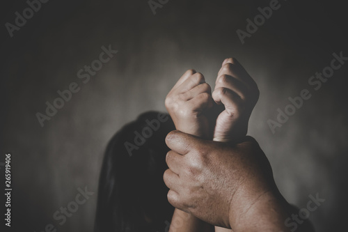 Children violence. Man's hand holding tight girl's hands