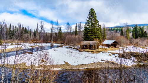 Old huts along the snow and ice lined creeks in winter time Wells Gray Provincial Park in the Cariboo Mountains of British Columbia, Canada